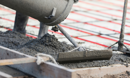 Concrete being poured and leveled. 
