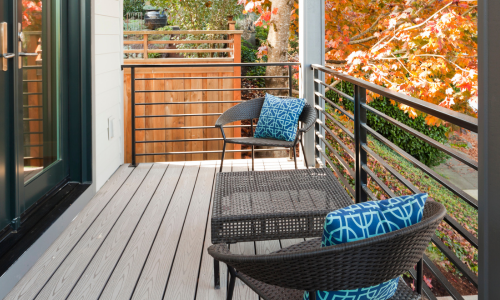 An outdoor deck surrounded by autumn foliage.