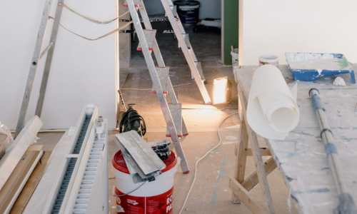 A room being renovated, full of contractor supplies.