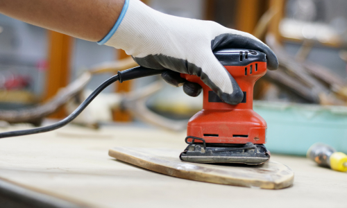 A close up of an electric sander.